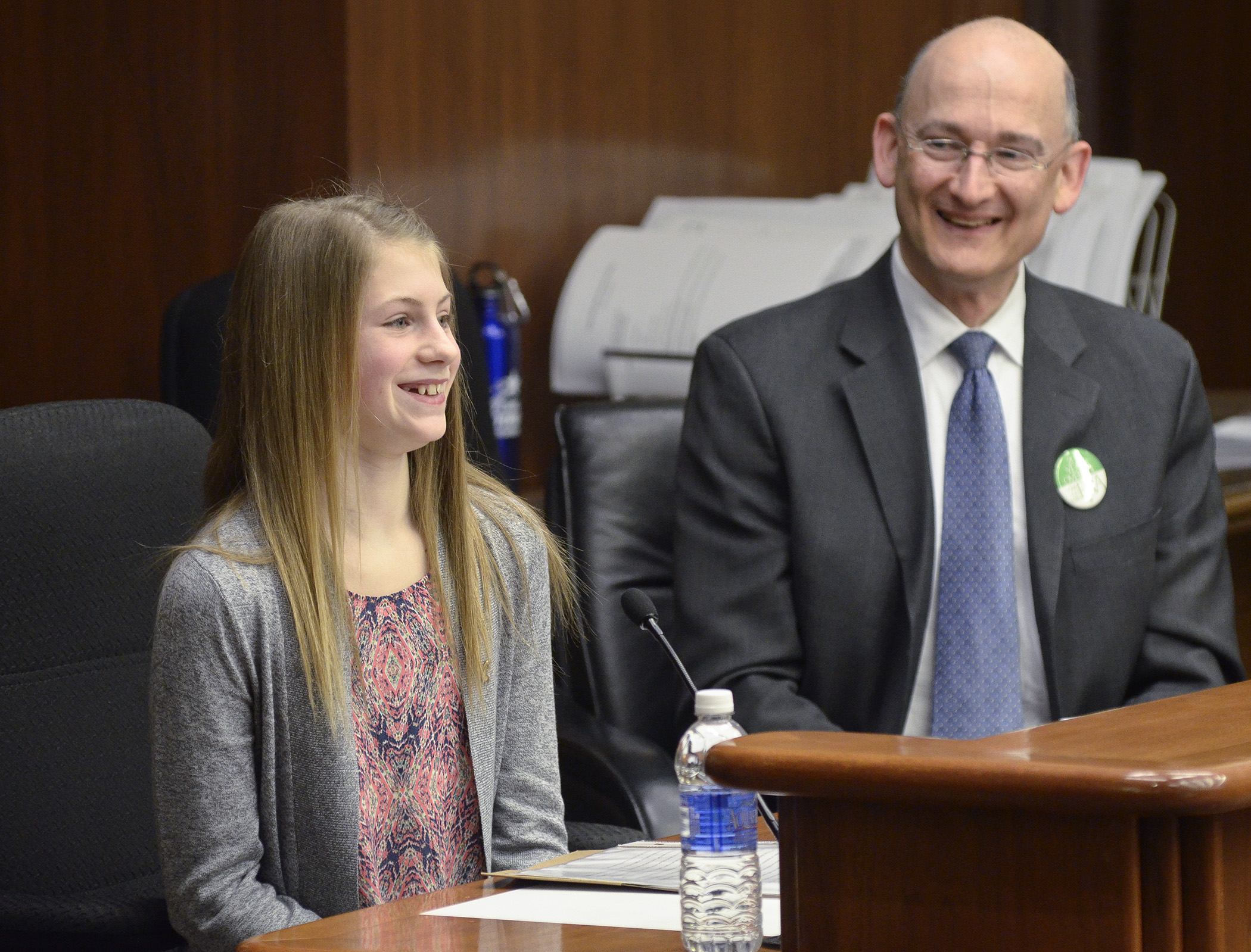 Sophie Davis, 12, a student at Sunrise Park Middle School in White Bear Lake, testifies before the House Education Finance Committee March 5 in support of a bill sponsored by Rep. Peter Fischer, right, that would provide grant funding for water conservation programming in Minnesota schools. Photo by Andrew VonBank